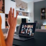 Woman using laptop for video conference to connect with her family, colleagues and friends from home